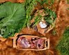 The ingredients consisting of the roe deer meat, various herbs, rhubarb leaves, and salt.