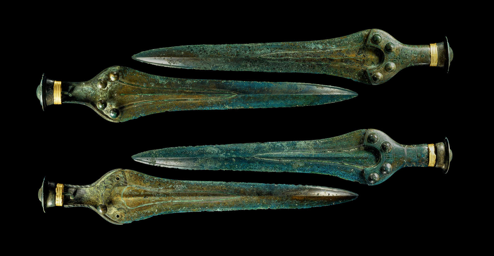 The front and back sides of the two swords from the Nebra hoard.